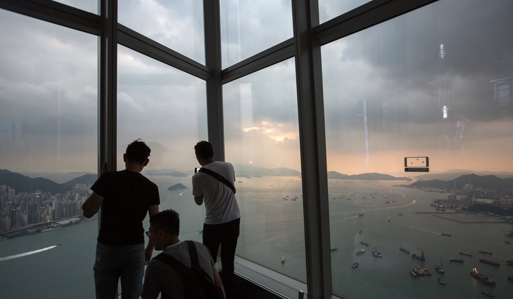 Visitors take in the sunset and a panoramic view of Hong Kong. Photo: EPA Visitors take in the sunset and a panoramic view of Hong Kong. Photo: EPA