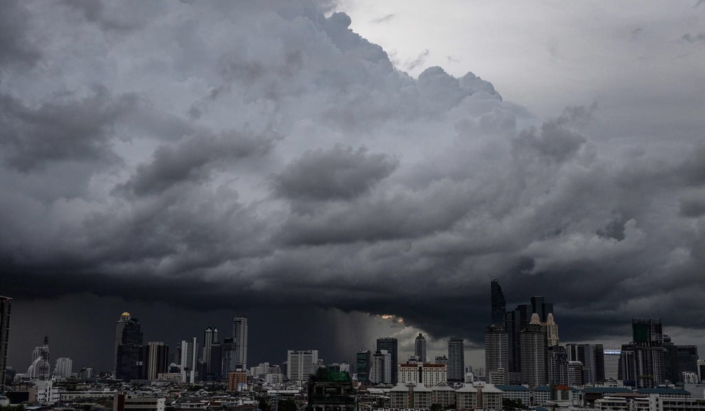 Rain clouds over the central business district in Bangkok. “The waterborne city inspirits our undoing,” a character writes to his brother in an early chapter of Bangkok Wakes To Rain. Photo: AFP