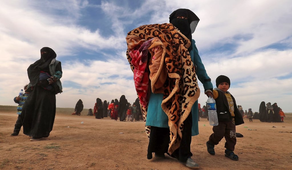Civilians fleeing Islamic State’s embattled holdout of Baghouz gather in a field during an operation by the Syrian Democratic Forces to expel the group from the area. Photo: Delil Souleiman/AFP