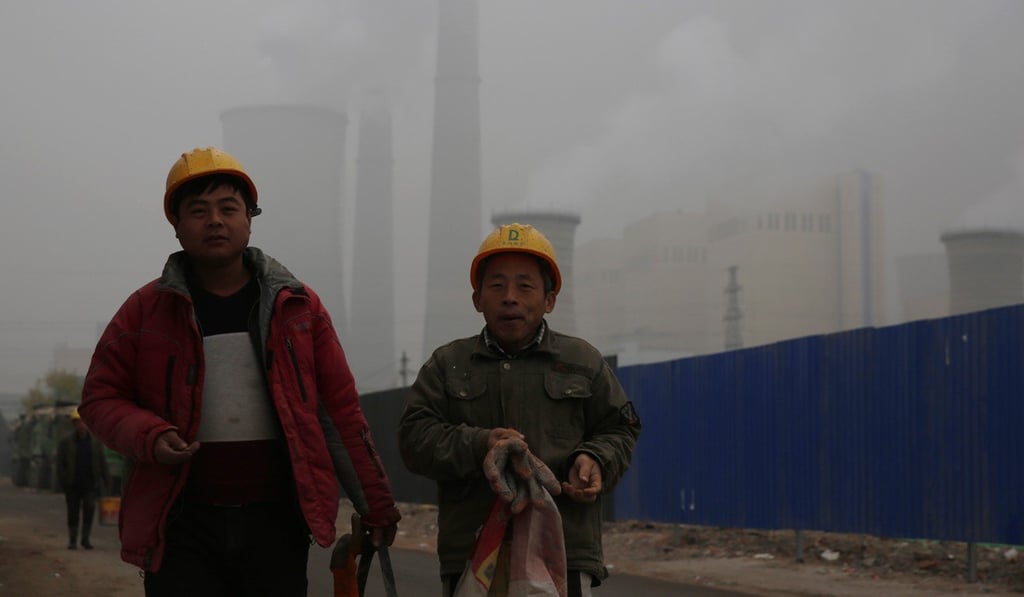 Chinese migrant workers walk near a power plant during a polluted day in Beijing in December 2018. Chinese President Xi Jinping has made environmental protection one of his top three priorities. Photo: EPA-EFE