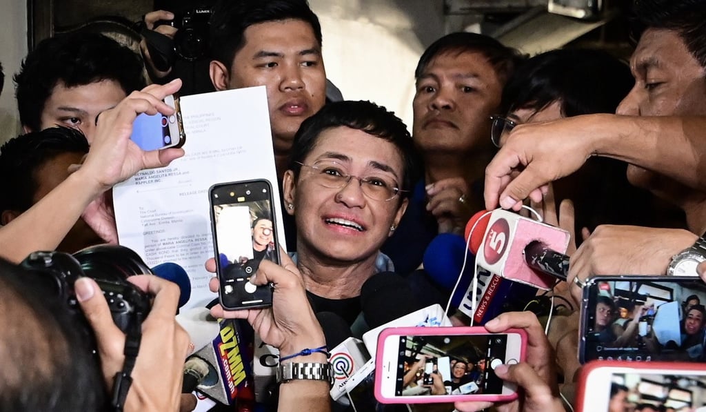 Maria Ressa (centre), CEO and executive editor of online news site Rappler, displays her release order after posting bail at a court in Manila, the Philippines, on February 14. Ressa had been arrested by Philippine authorities on libel charges the previous day. Photo: EPA-EFE