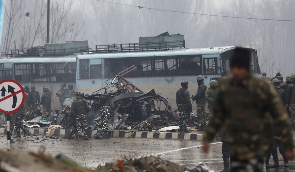 Indian security forces inspect the site of the blast in Pulwama on February 14. Photo: EPA