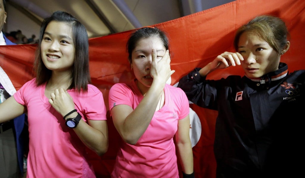 Hong Kong’s Chan Ho-ling, Annie Au Wing-chi and Ho Tze-lok celebrate winning the women’s team squash final at the 2018 Asian Games. Photo: AP