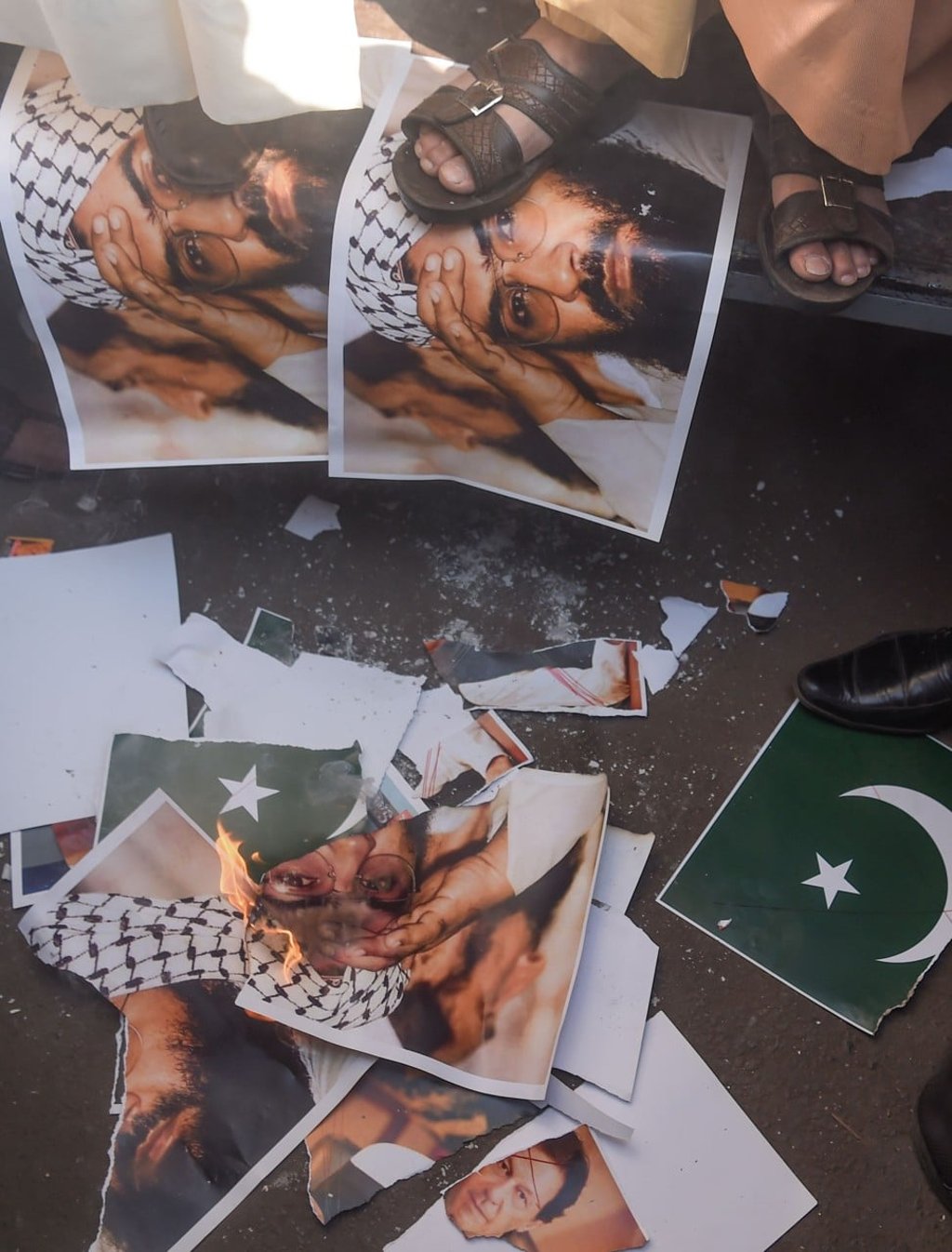 Indian Muslims stamp on a scratched photo of Masood Azhar, who founded Jaish-e-Mohammad. Photo: AFP