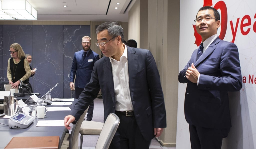 Liang Hua, centre, chairman of Huawei's board of directors leaves a media event in Toronto on Thursday. Photo: AP Liang Hua, centre, chairman of Huawei's board of directors leaves a media event in Toronto on Thursday. Photo: AP
