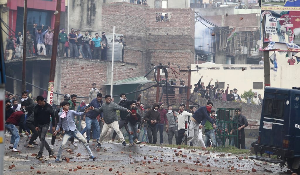 Protesters throw stones during a clash between communities in Jammu, in Indian-controlled Kashmir, on Friday, a day after militants killed 41 Indian troops in a bomb attack. Photo: AP Protesters throw stones during a clash between communities in Jammu, in Indian-controlled Kashmir, on Friday, a day after militants killed 41 Indian troops in a bomb attack. Photo: AP