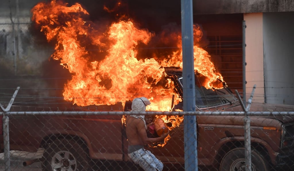 A vehicle is set ablaze at a Venezuelan police station on the border with Pacaraima, Roraima State, Brazil, where clashes with security forces erupted amid efforts to take aid into the crisis-hit country. Photo: AFP A vehicle is set ablaze at a Venezuelan police station on the border with Pacaraima, Roraima State, Brazil, where clashes with security forces erupted amid efforts to take aid into the crisis-hit country. Photo: AFP