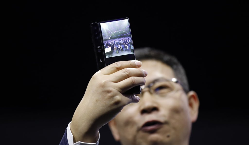Richard Yu, chief executive officer of Huawei, takes a photograph as he presents the Mate X foldable 5G mobile device during a launch event ahead of the MWC Barcelona in Barcelona, Spain, on Sunday. Photo: Bloomberg Richard Yu, chief executive officer of Huawei, takes a photograph as he presents the Mate X foldable 5G mobile device during a launch event ahead of the MWC Barcelona in Barcelona, Spain, on Sunday. Photo: Bloomberg