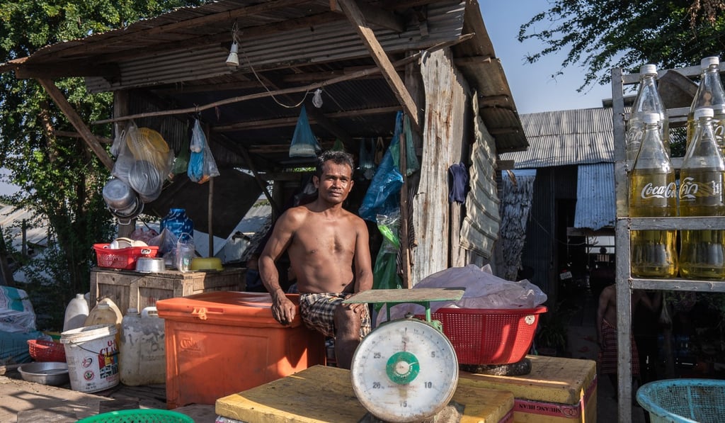 Seng Oeun sits in front of the store he runs with his wife by Boeung Tamouk, in the northern part of the Cambodian capital. Photo: Enric Catala
