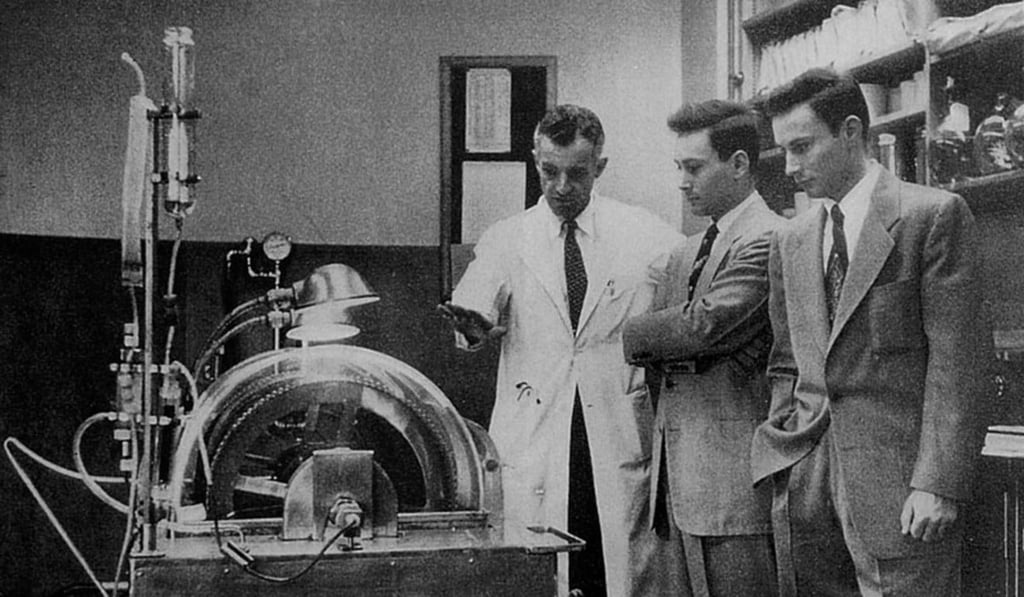 Dr John Merrill (left), part of the team including Dr Joseph Murray that performed the world’s first successful kidney transplant, showing the Herrick twins an early dialysis machine.