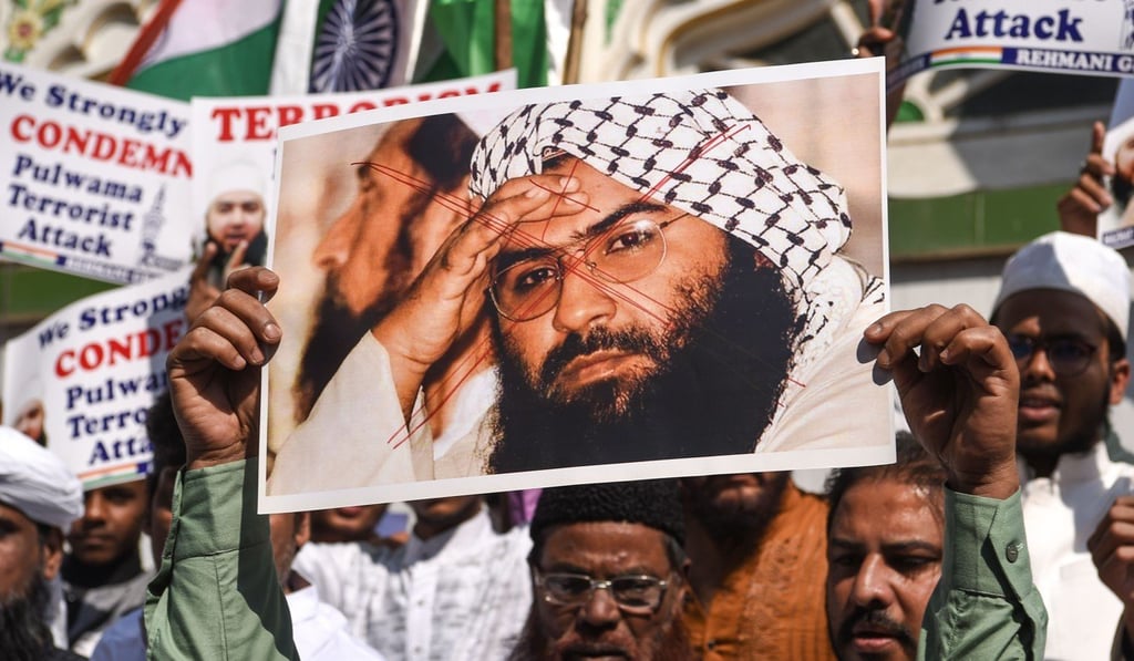 Protesters in India hold aloft a scratched photo of Jaish-e-Mohammad chief Masood Azhar. Photo: AFP Protesters in India hold aloft a scratched photo of Jaish-e-Mohammad chief Masood Azhar. Photo: AFP