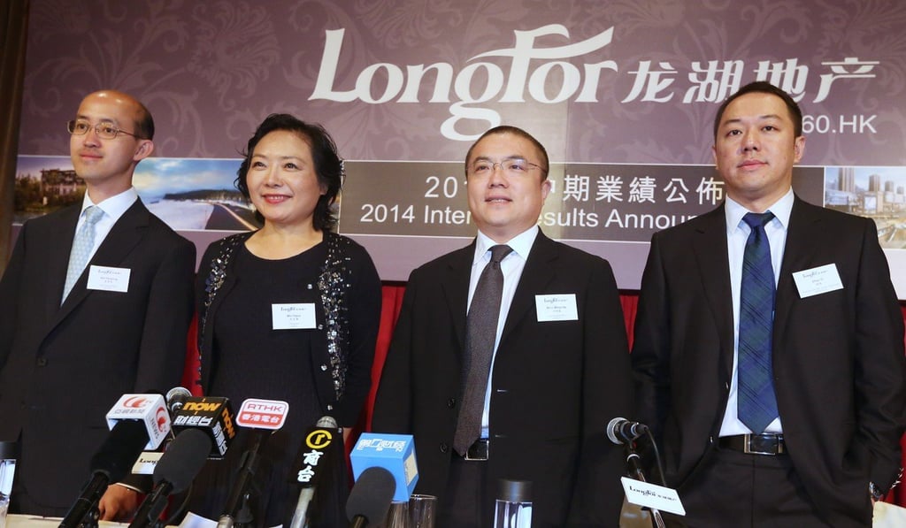 Wu Yajun (second left), chairman of Longfor, with other company executives (from left) Wei Huaning, Shao Mingxiao and Zhao Yi, in August 2014. Photo: Sam Tsang