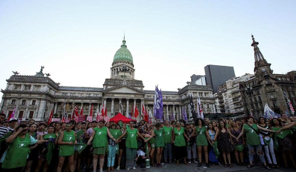 Activists hold hands during a demonstration for the right to abortion in Buenos Aires on February 19. Photo: Reuters