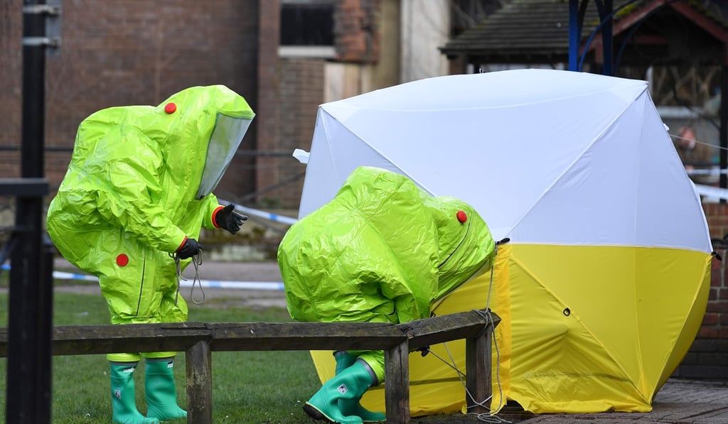 Members of the emergency services in green biohazard encapsulated suits erect a tent over the bench where a man and a woman were found on March 4 in critical condition at The Maltings shopping centre in Salisbury. Photo: AFP Members of the emergency services in green biohazard encapsulated suits erect a tent over the bench where a man and a woman were found on March 4 in critical condition at The Maltings shopping centre in Salisbury. Photo: AFP