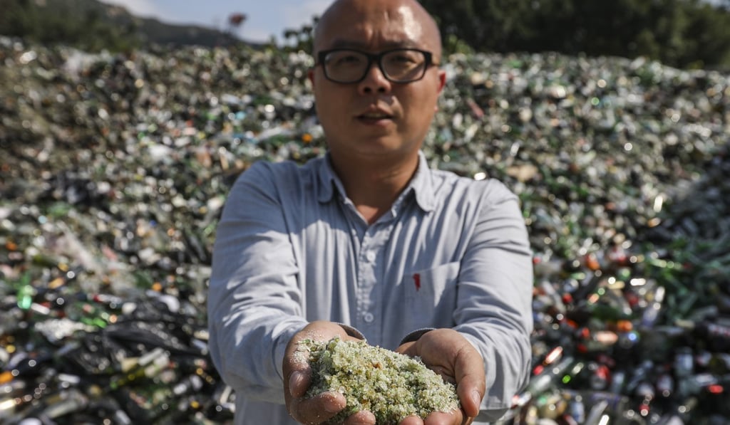 Delvin Cheng shows grains of sand processed from waste glass. Photo: Nora Tam