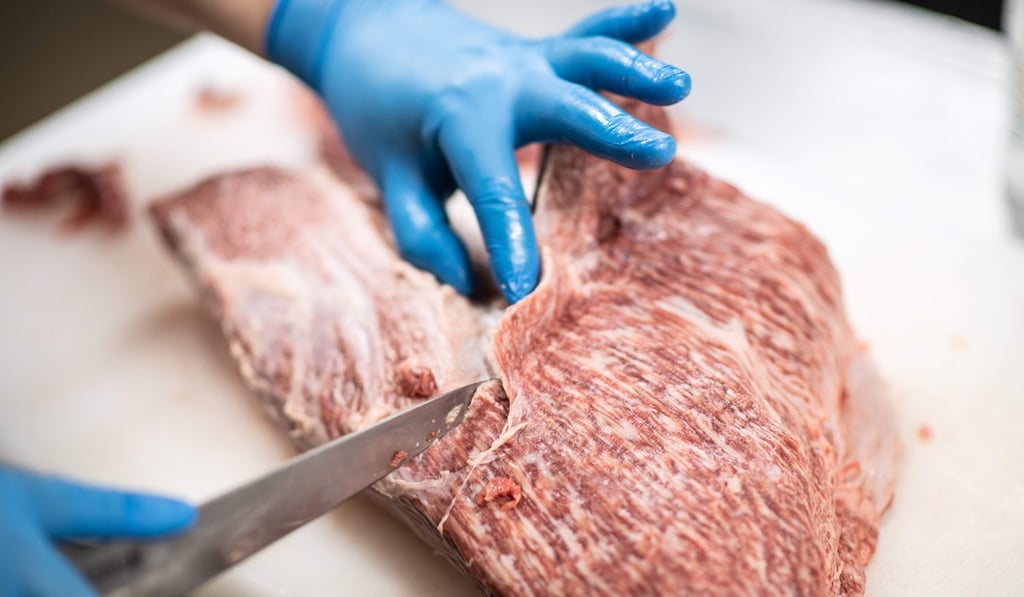 An employee slicing Wagyu beef at a restaurant in Takayama. Photo: AFP