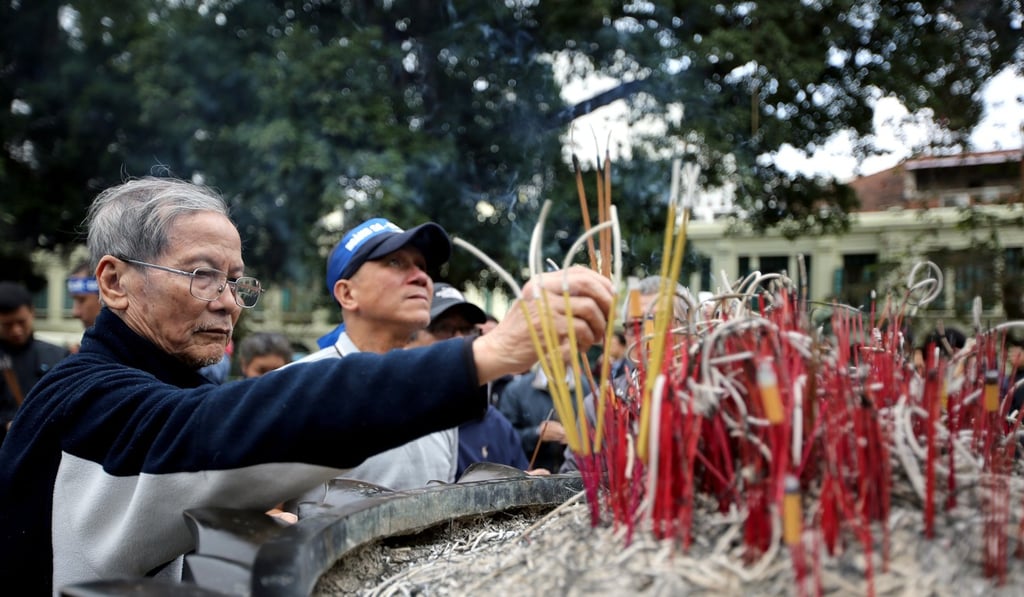 A Vietnamese man prays at a rally marking the 38th anniversary of the border war with China, at Hoan Kiem lake in Hanoi, Vietnam. Photo: EPA