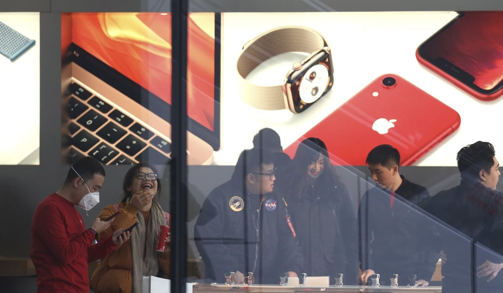 Customers visit an Apple store in Beijing. Photo: AP