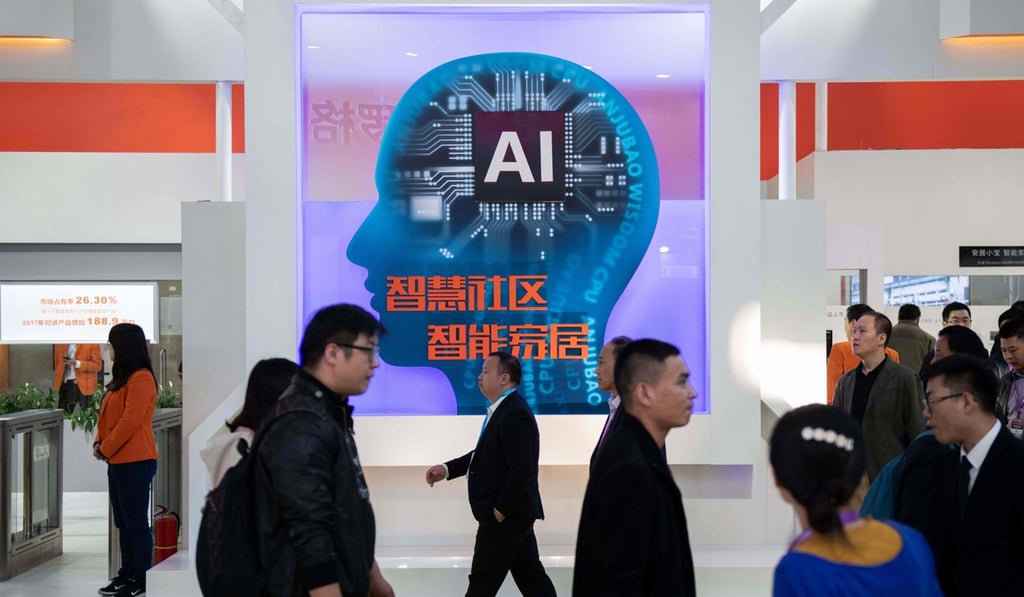 Visitors walk past a stand with AI security cameras using facial recognition technology in Beijing on October 24, 2018. Photo: AFP
