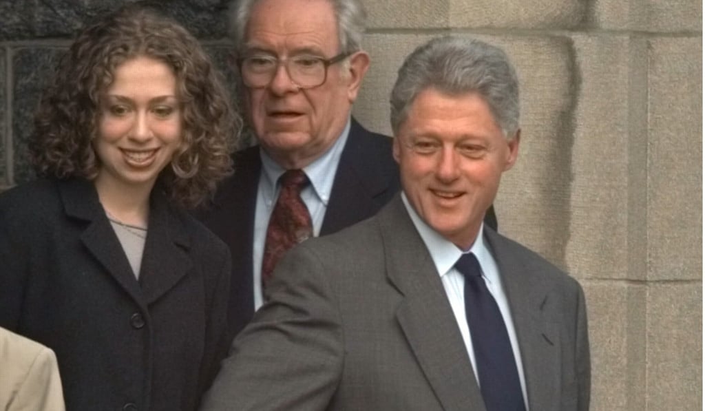 Bill Clinton and daughter Chelsea leave a church in Washington in December 1998. Man in centre is unidentified. Photo: AP