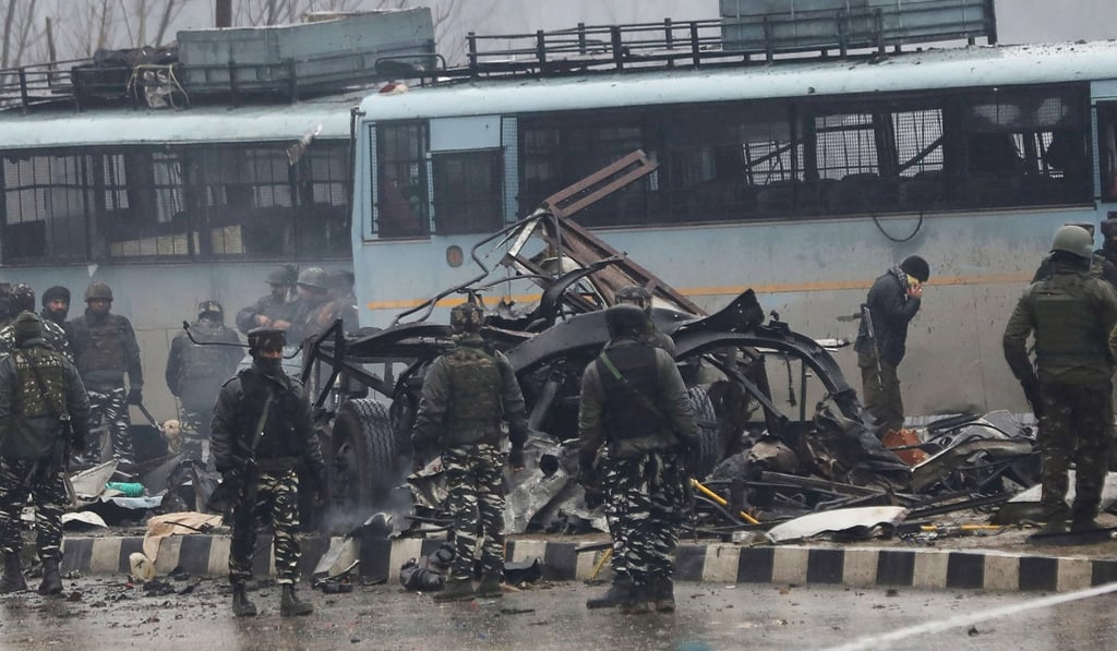 Indian security forces inspect the remains of a vehicle following an attack on a paramilitary Central Reserve Police Force convoy near Awantipur town in the Lethpora area of Kashmir on February 14. Photo: AFP