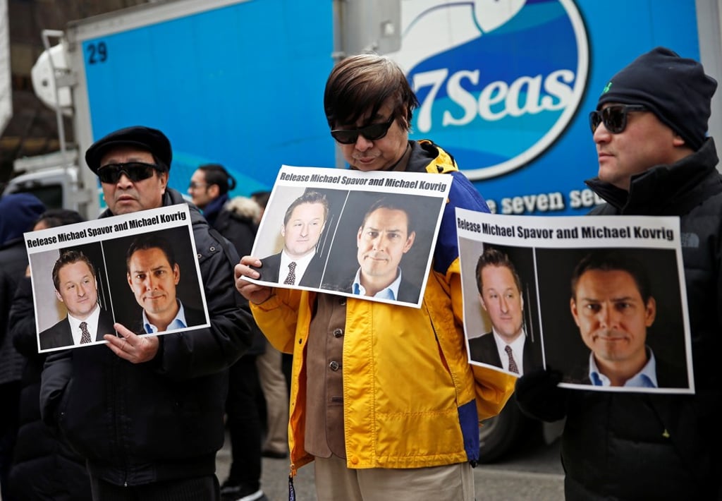 People hold placards calling for China to release Canadian detainees Michael Spavor and Michael Kovrig outside the British Columbia Supreme Court in Vancouver on Wednesday. Photo: Reuters