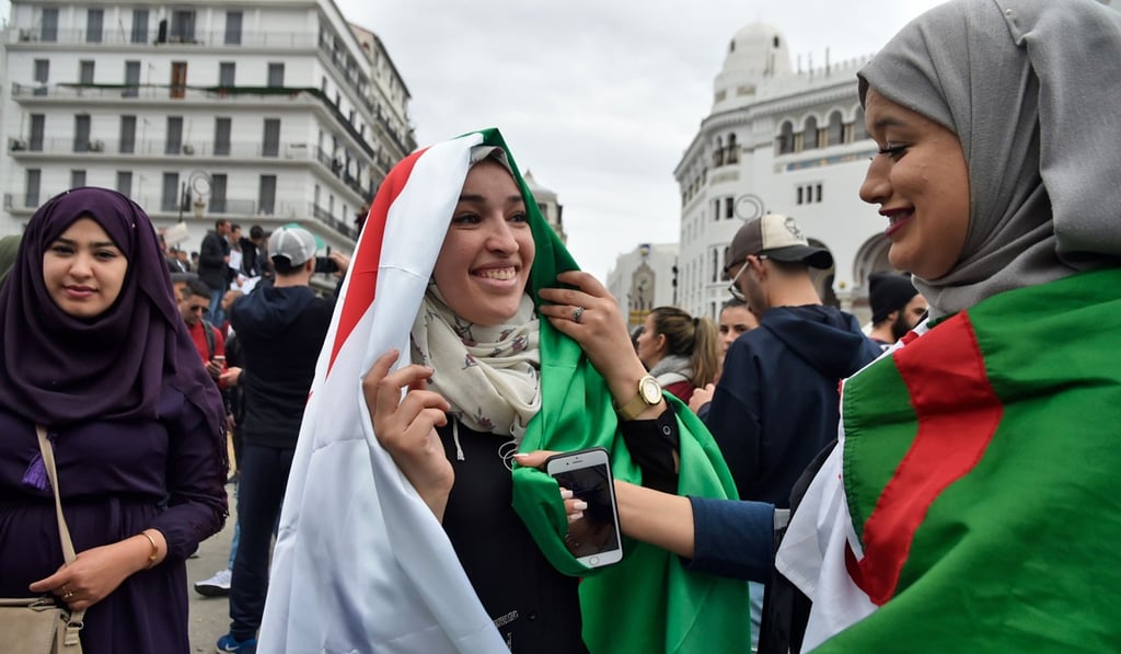 Female protesters wearing flags at the protest. Photo: AFP
