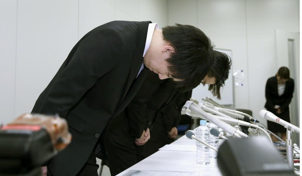 Staff of cryptocurrency exchange Coincheck bow in apology after some US$534 million of the NEM cryptocurrency disappeared due to hacking. Photo: Kyodo