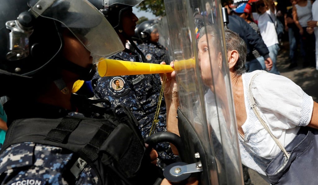 Guaido supporters confronting police in Caracas. Photo: Reuters