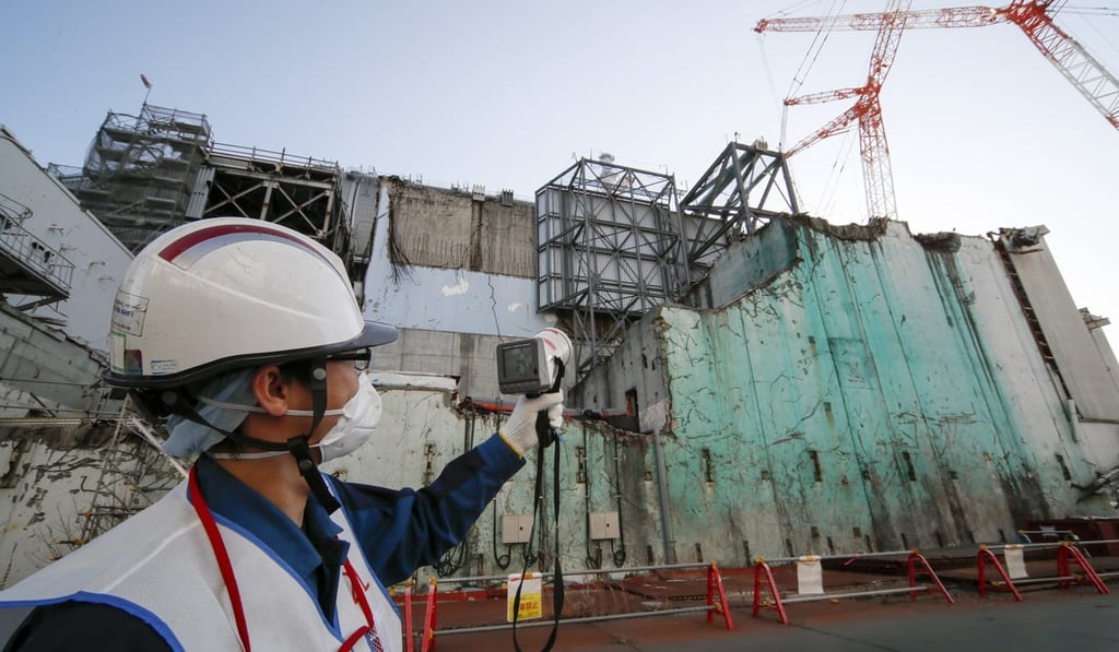A worker measures radiation levels at the tsunami-crippled Fukushima Daichi Nuclear Power Plant. Photo: EPA