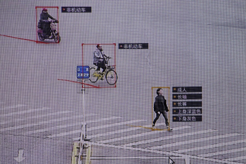 SenseTime surveillance software identifying details about people and vehicles during a demonstration at the company's office in Beijing, China. The descriptions next to the woman reads: Adult, long sleeves, long pants, navy blue top, grey bottom. (Picture: Reuters) SenseTime surveillance software identifying details about people and vehicles during a demonstration at the company's office in Beijing, China. The descriptions next to the woman reads: Adult, long sleeves, long pants, navy blue top, grey bottom. (Picture: Reuters)
