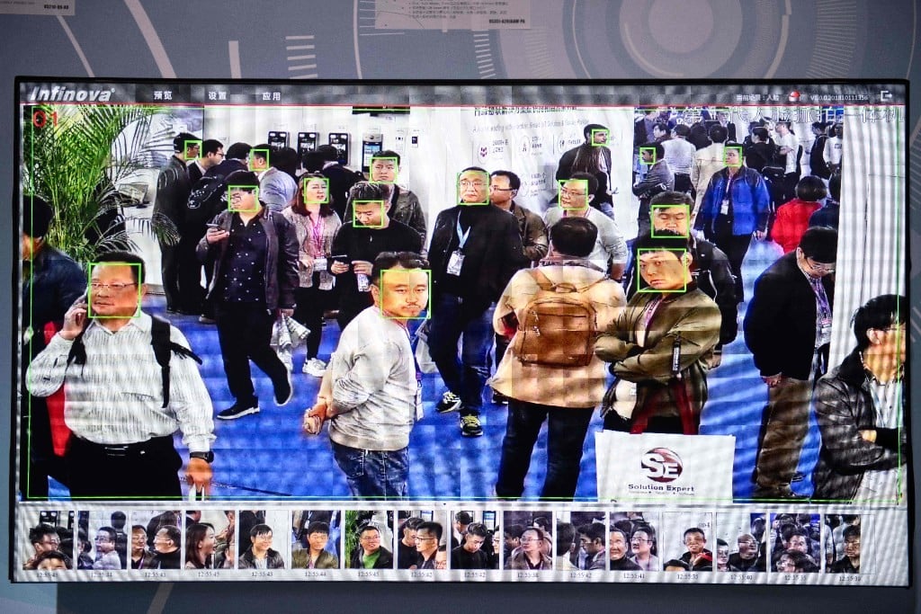 Visitors at the China International Exhibition on Public Safety and Security, filmed by security cameras with facial recognition technology, in Beijing on October 24. (Picture: AFP)