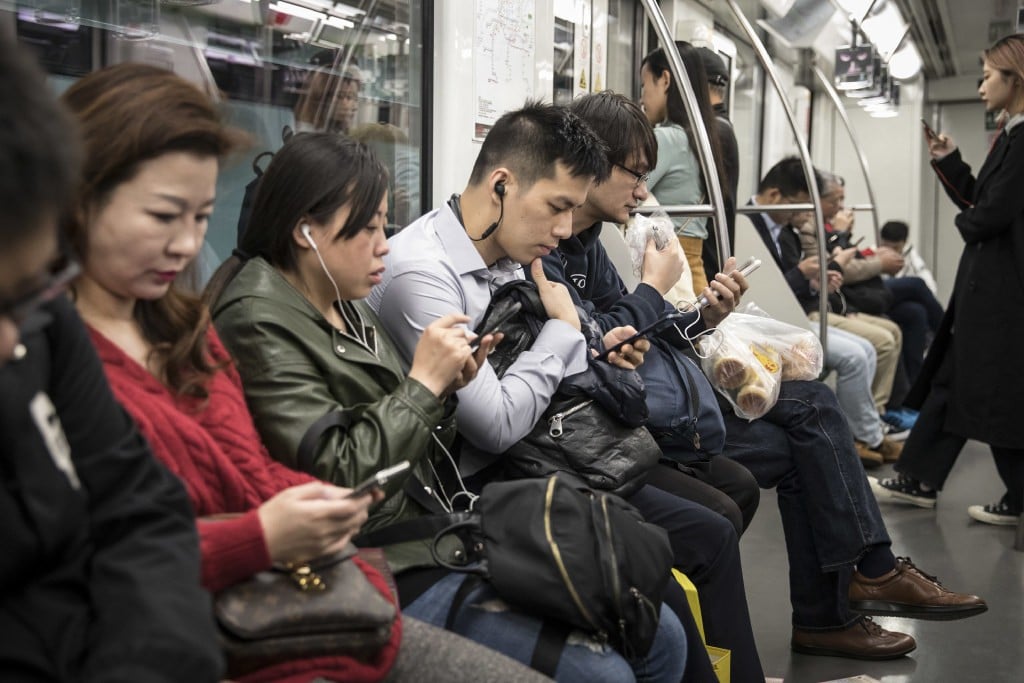Commuters with their smartphones in Shanghai. (Picture: Qilai Shen/Bloomberg)