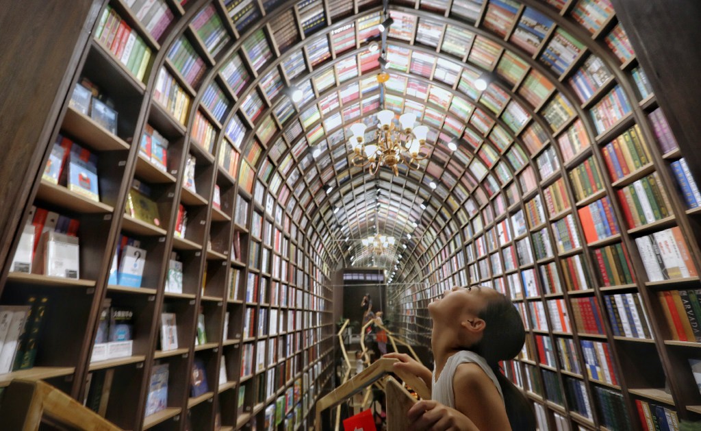 A girl looks up at the ceiling at a newly opened bookstore in Beijing on July 19, 2019. (Picture: Simon Song/SCMP) A girl looks up at the ceiling at a newly opened bookstore in Beijing on July 19, 2019. (Picture: Simon Song/SCMP)