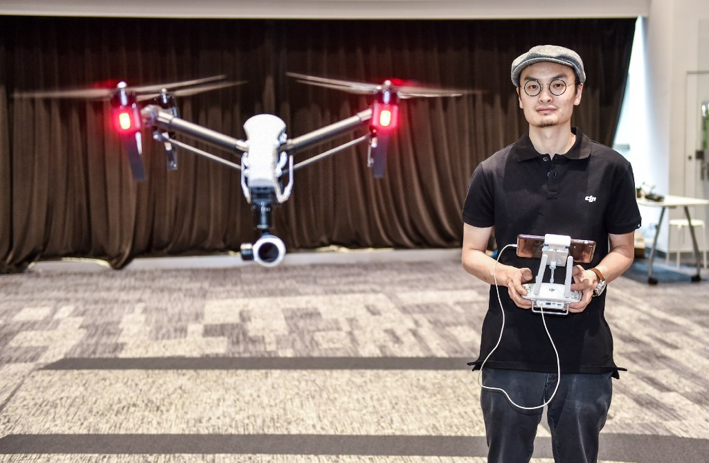 Frank Wang, founder of DJI, plays with a drone in his company headquarters in Shenzhen on May 22, 2015. (Picture: Mao Siqian/Xinhua) Frank Wang, founder of DJI, plays with a drone in his company headquarters in Shenzhen on May 22, 2015. (Picture: Mao Siqian/Xinhua)