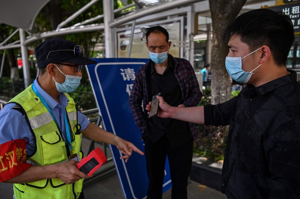QR health code use is dropping in China, but it’s still a requirement for gaining entrance to many offices and businesses. (Picture: Hector Retamal/AFP)