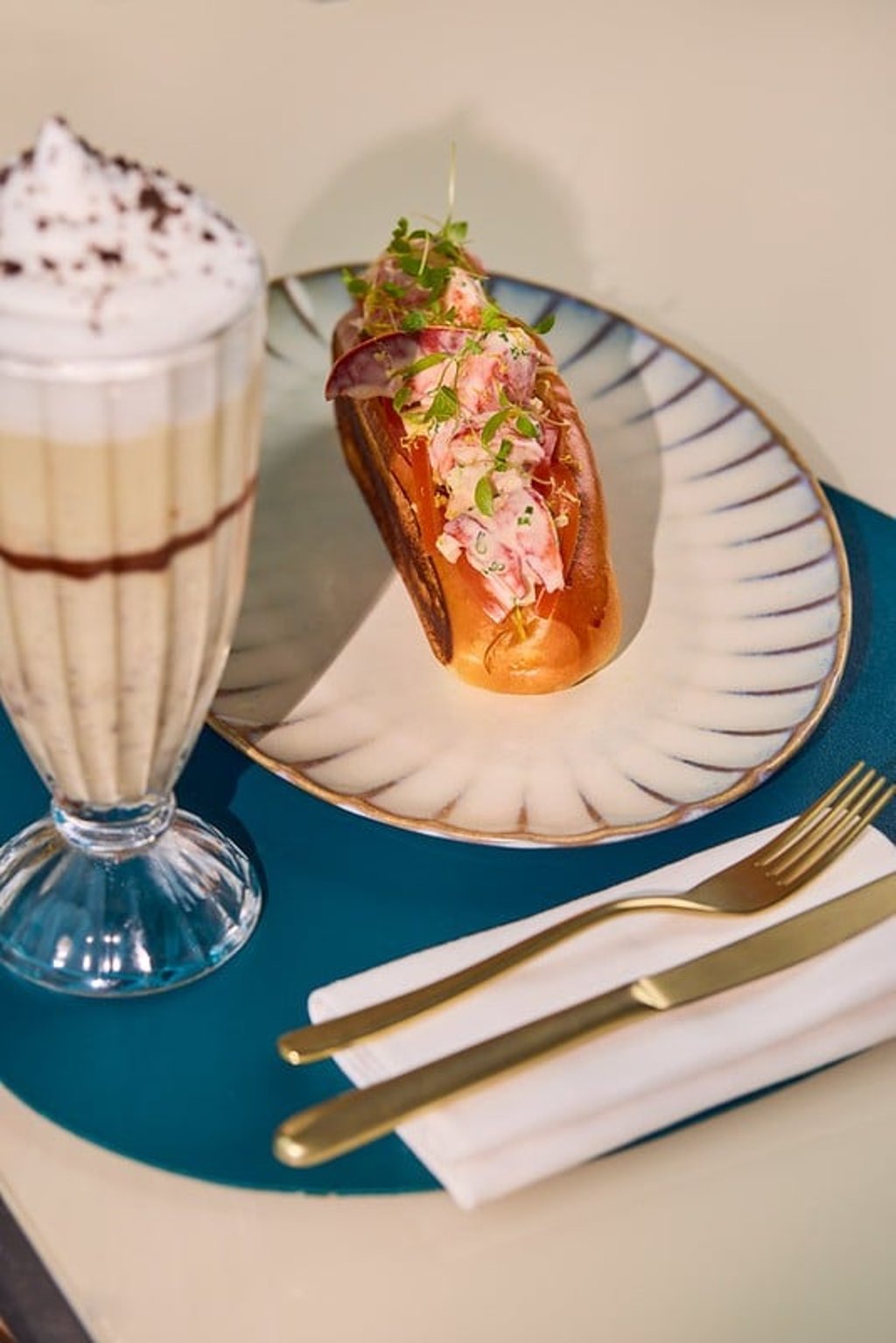 Canadian lobster, green apple and celery bring a fresh summer lift to the Lobster Bun, paired with Harbour Crunch, a cookies-and-cream shake with a silken texture and delicate bite. Canadian lobster, green apple and celery bring a fresh summer lift to the Lobster Bun, paired with Harbour Crunch, a cookies-and-cream shake with a silken texture and delicate bite.