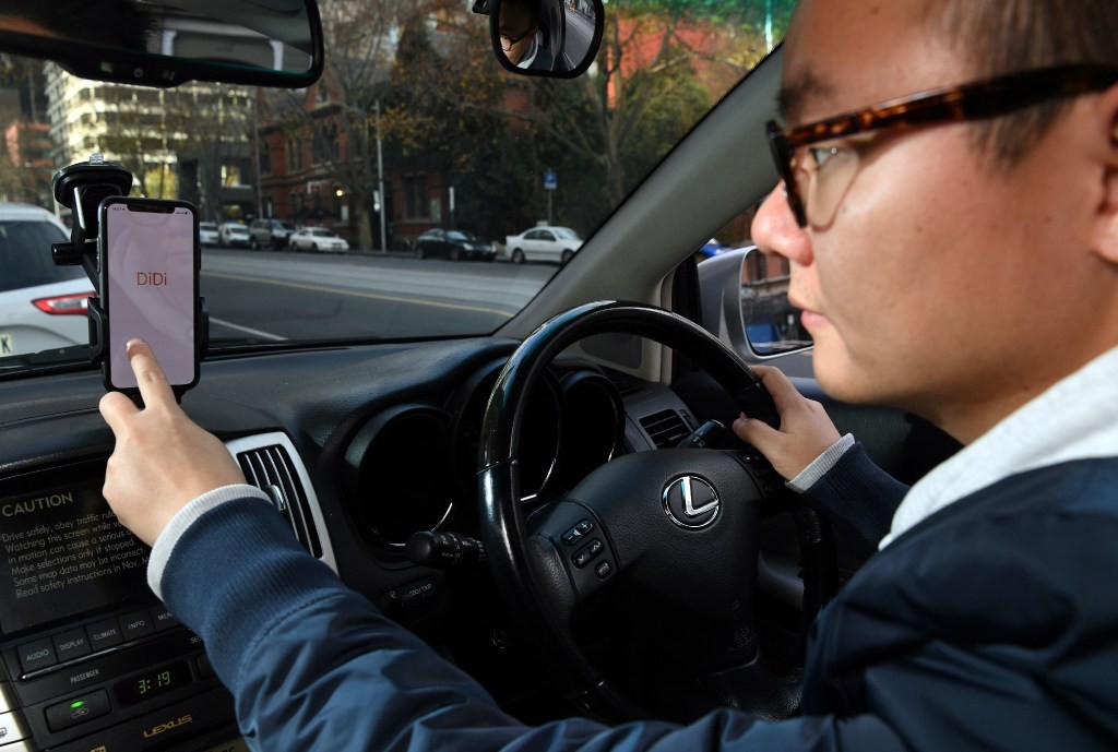 A staffer demonstrates the Didi app on his smartphone in Melbourne, Australia on June 25, 2018. (Picture: AFP Photo) A staffer demonstrates the Didi app on his smartphone in Melbourne, Australia on June 25, 2018. (Picture: AFP Photo)