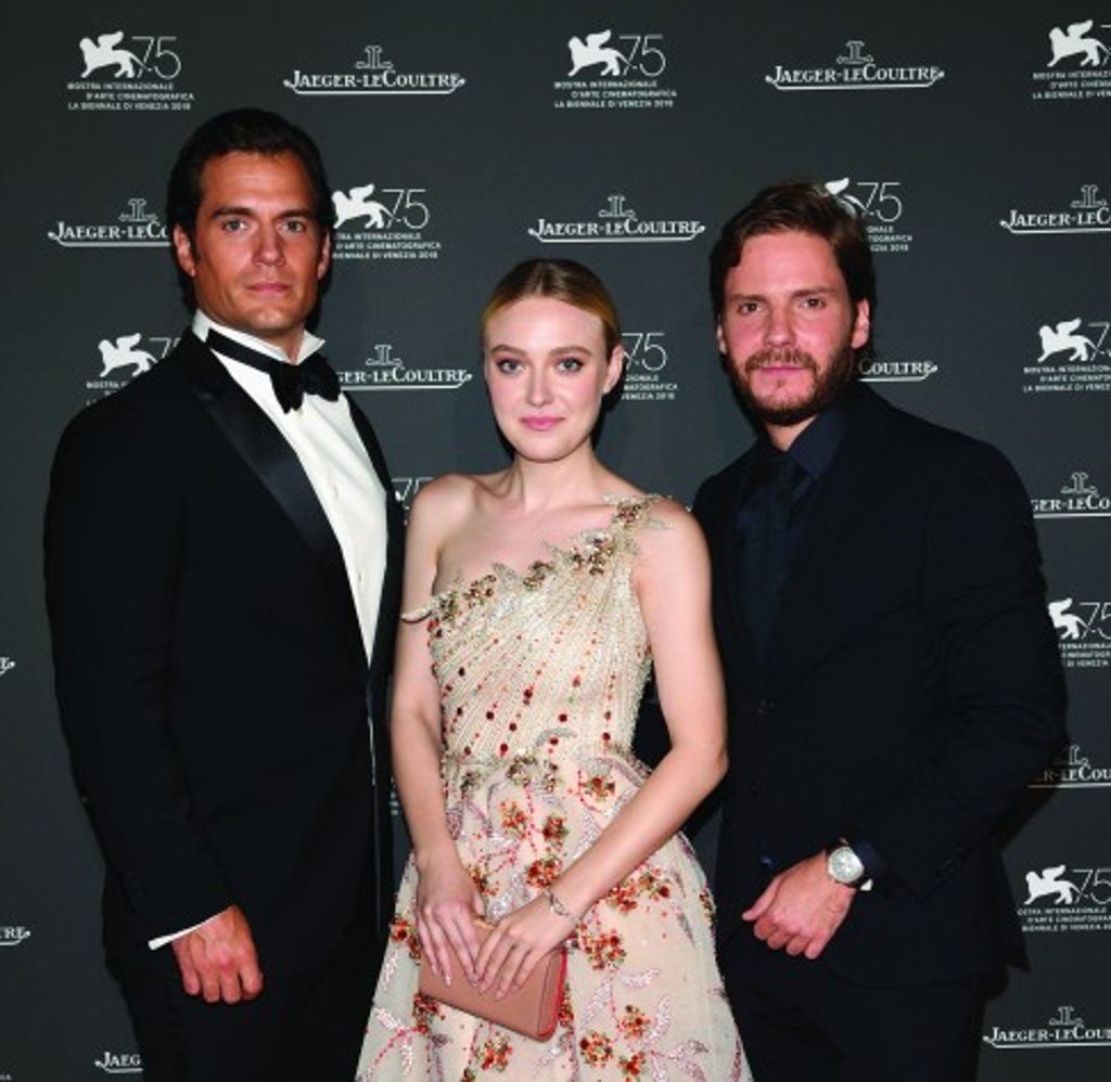 Henry Cavill (left) and Daniel Brühl (right) wear watches from the 2018 Jaeger-LeCoultre Polaris collection, while Dakota Fanning (centre) wears a Jaeger-LeCoultre 101 Feuille timepiece in pink gold.