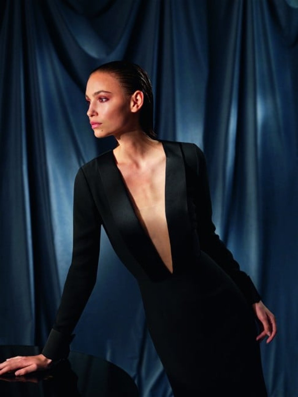 Sleek long black satin and cady dress with long sleeves and a plunging neckline.