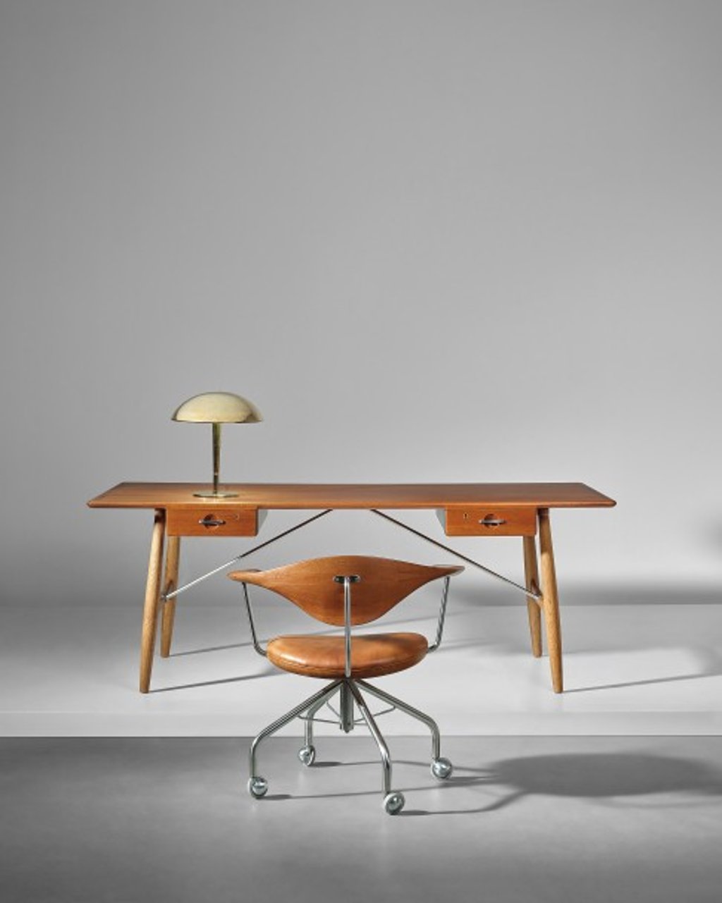 Hans J. Wegner’s Early ‘Architect’s desk’, Early table lamp and Paavo Tynell’s Early table lamp.