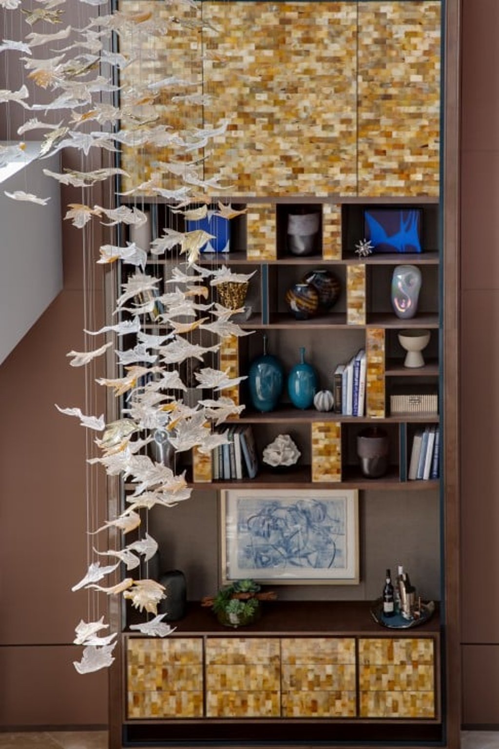 A shelving unit is clad in cow horn, the material creating a striking contrast with the objects housed within. (This photo was taken on February 20–21, 2021 at 23–39 Blue Pool Road. This photo has been processed by computerised imaging techniques and is for reference only.)