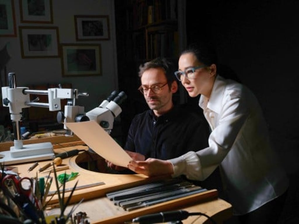 Cindy Chao (right) explores how to bring the Spring Cardamom Brooch to vivid life with a master artisan at her European atelier.