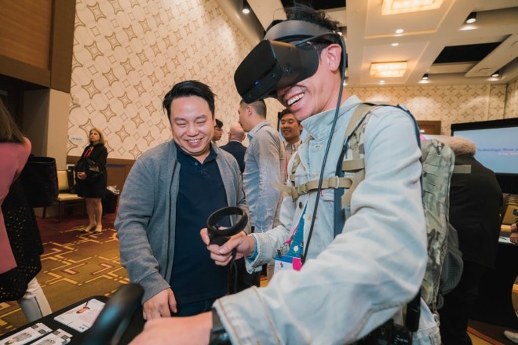 A member of the audience tried out a virtual reality (VR) experience by Hong Kong designer Roy Lo of Creote Studio, whose specialty is merging augmented reality and VR technologies with practical applications in various industries, including elderly care, health and safety and customer service.