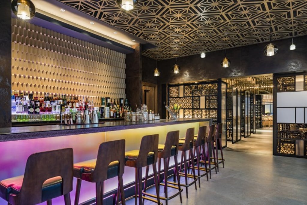 Unwind with fabulous cocktails at the bar of the rooftop Mizutani Japanese restaurant.