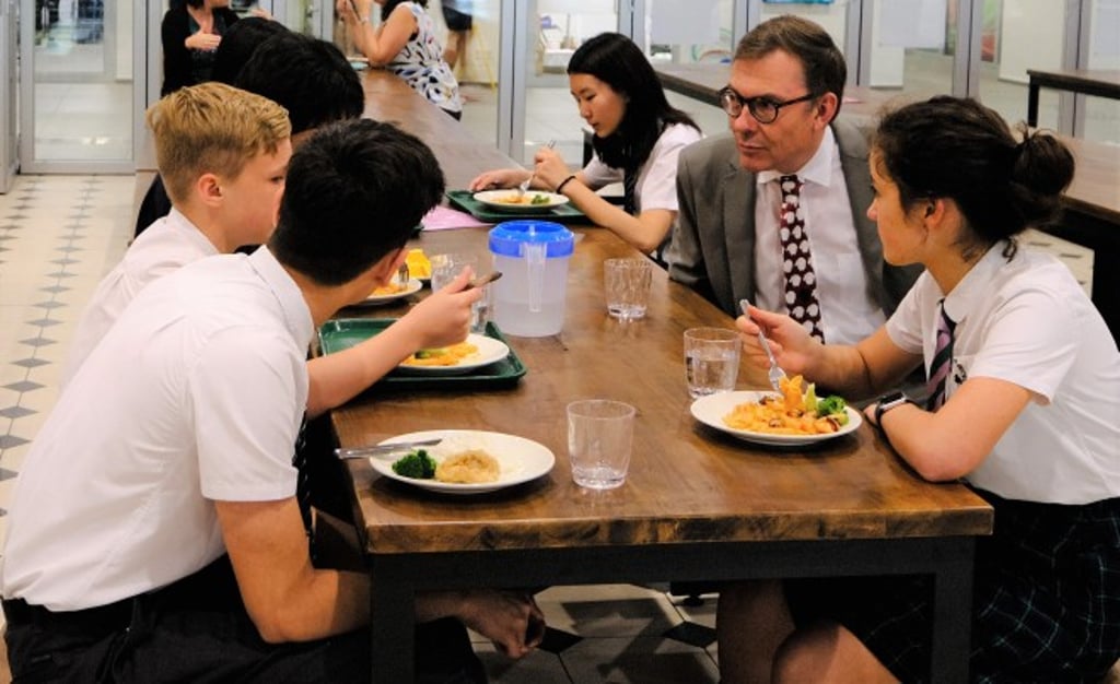 Robin Lister (right) chats with some students during their lunch break.