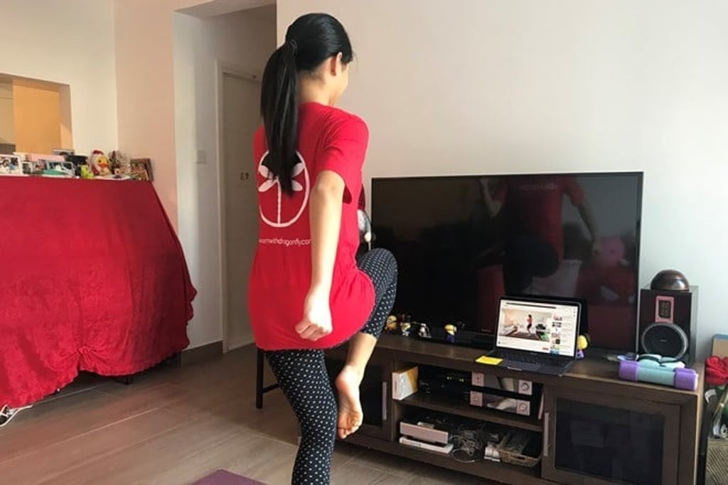 A Secondary student attends a PE lesson while interacting with her classmates virtually.