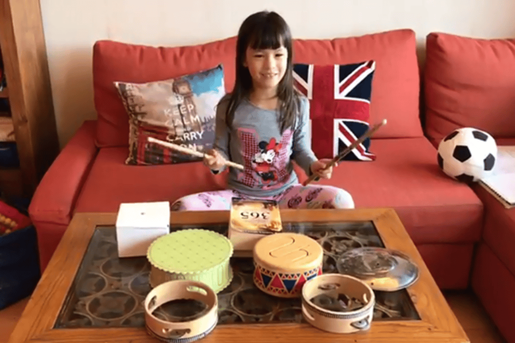 A Primary Year 2 student enjoys producing a series of rhymed percussion with various inverted vessels. A Primary Year 2 student enjoys producing a series of rhymed percussion with various inverted vessels.