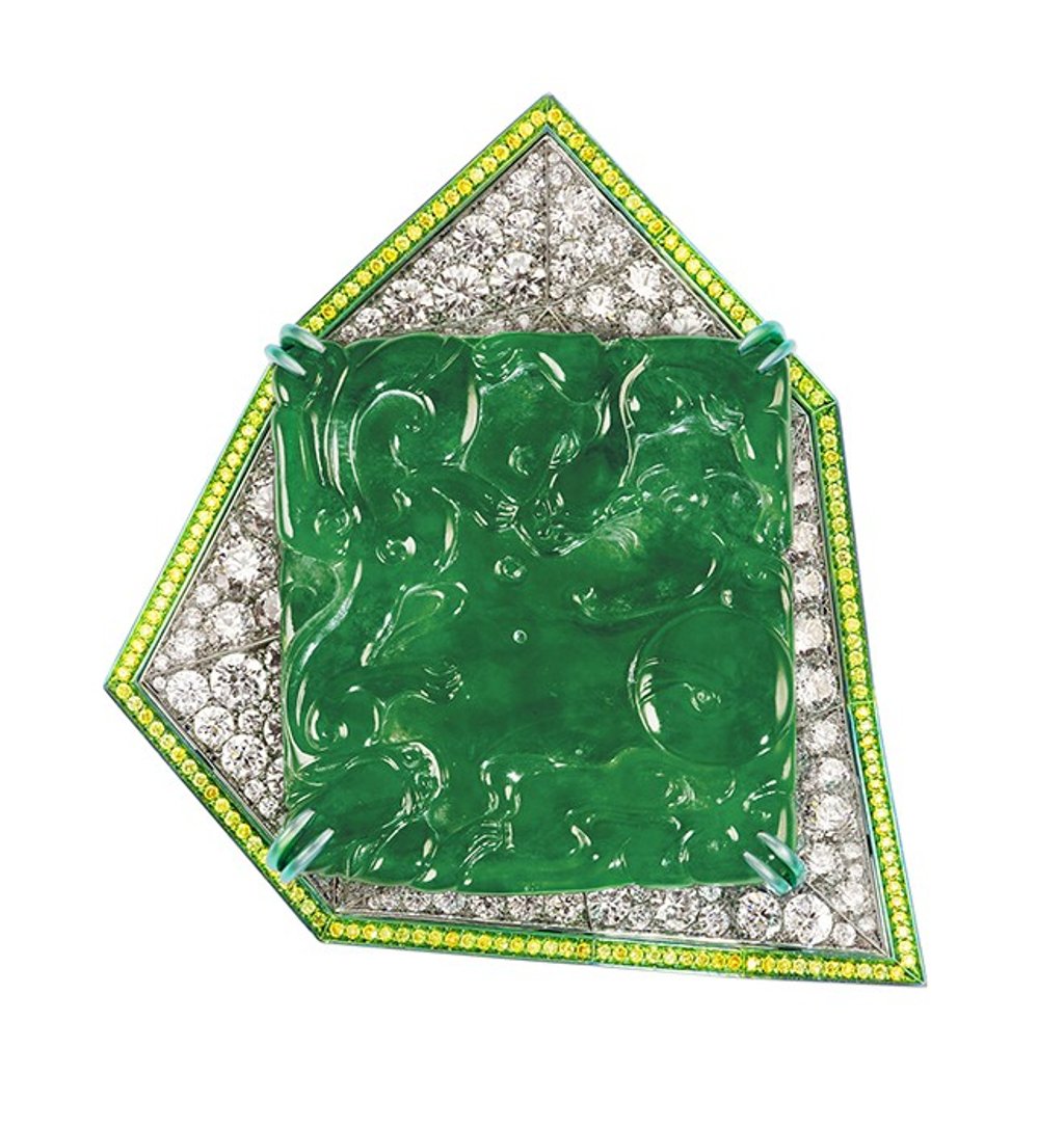 The “Sky Tower” features a 126.80-carat imperial jadeite plaque surrounded by round brilliant cut diamonds and fancy intense yellow diamonds mounted on a detachable pendant. The “Sky Tower” features a 126.80-carat imperial jadeite plaque surrounded by round brilliant cut diamonds and fancy intense yellow diamonds mounted on a detachable pendant.
