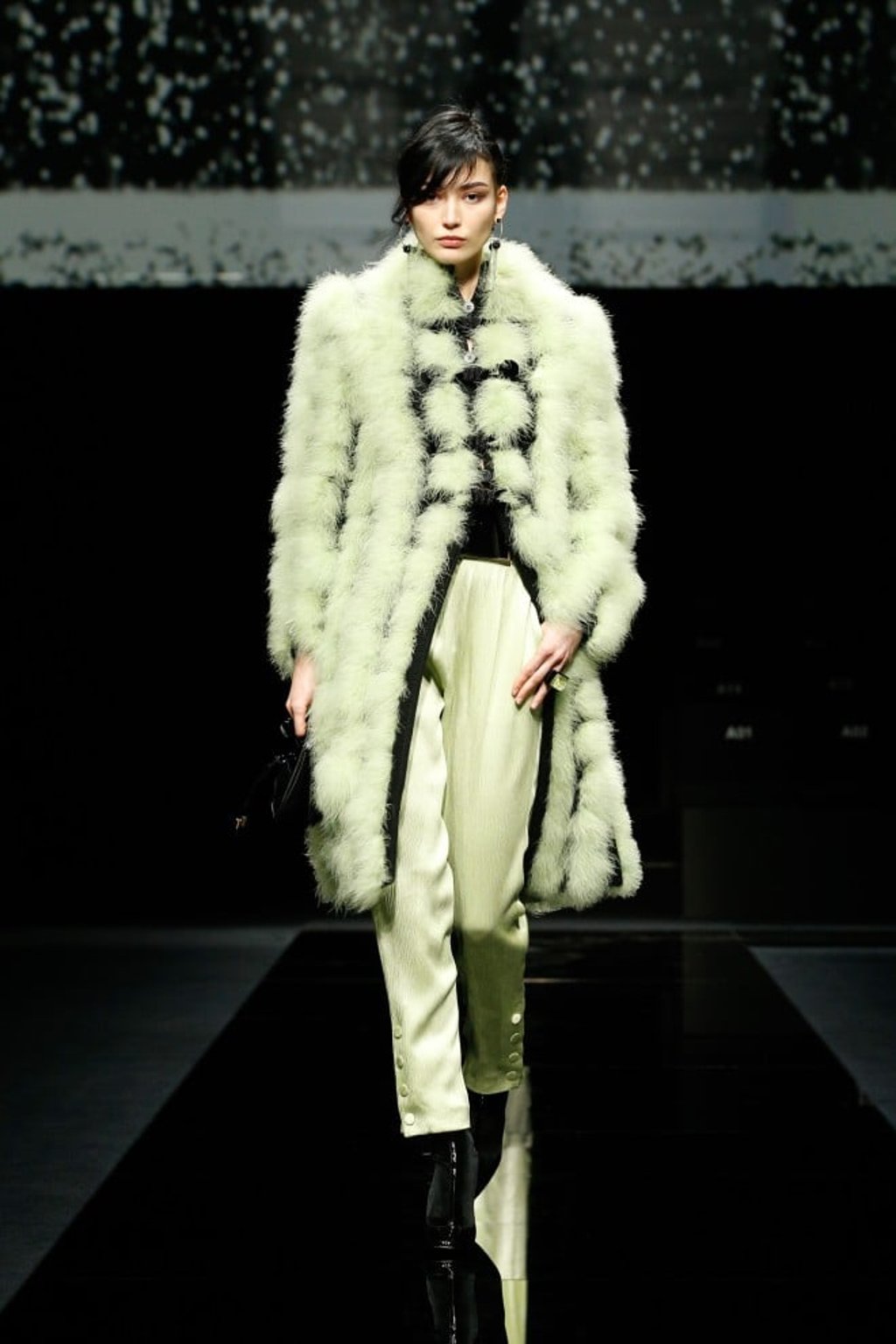 Cosy up in a luxe cachemire coat with marabou feathers effect in fresh lime coordinated crepe trousers when the temperature dips.
